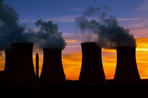 Silhouette of power plant at sunset